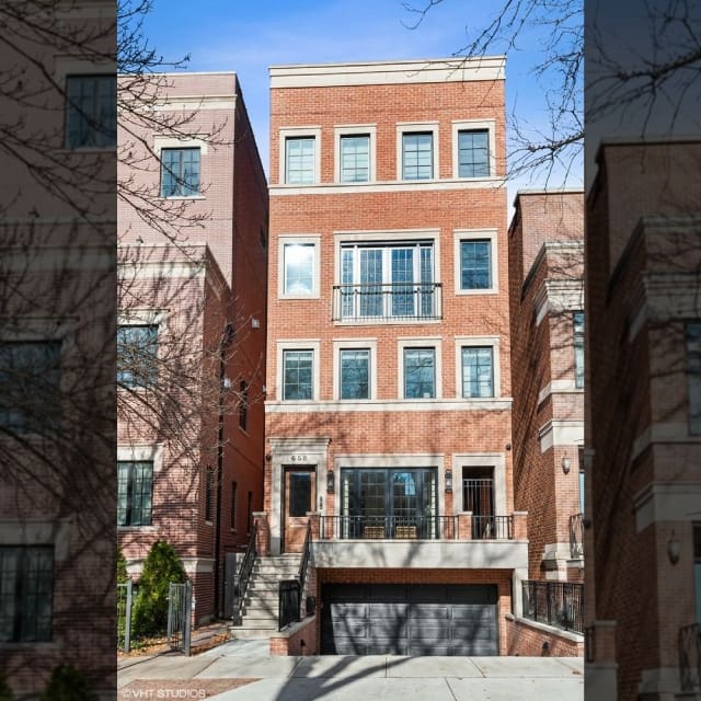 A multi-story brick residential building with balconies and large windows.