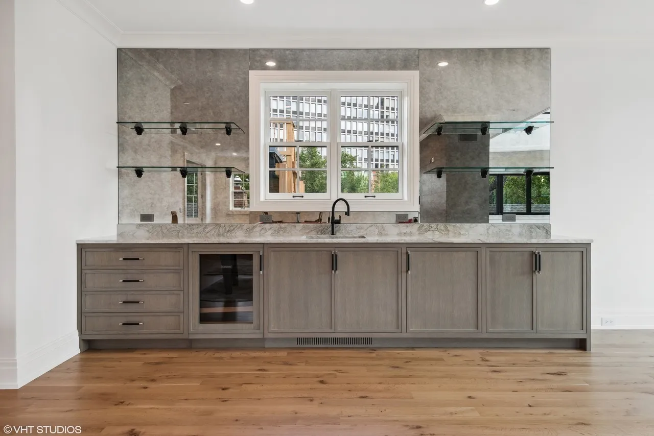 Modern kitchen with gray cabinets and window.