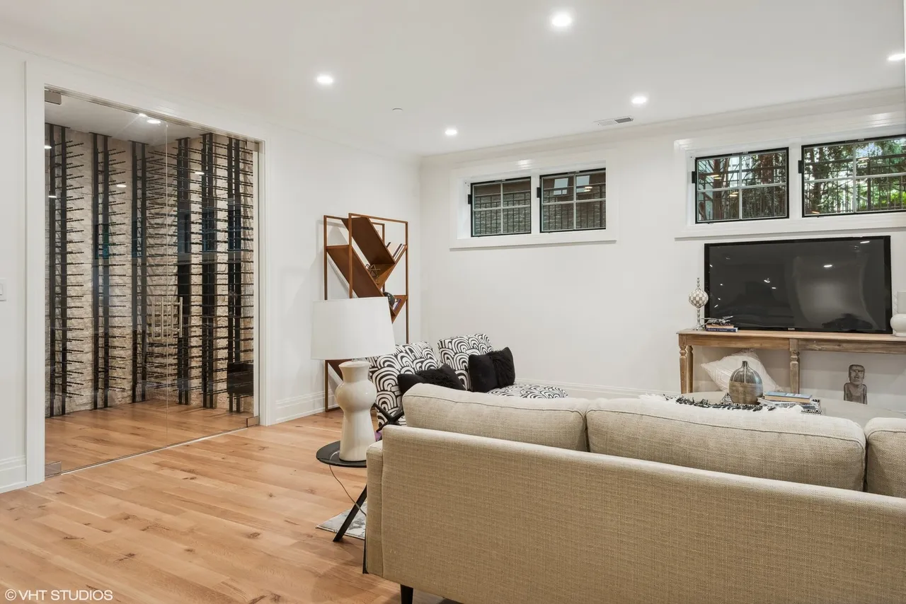Modern living room with wine rack display.
